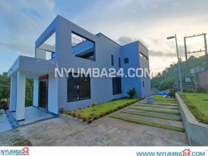 Contemporary Architectural Design 4 Bedroom Double Storey House For Sale In Nyambadwe, Blantyre, Malawi - With Double Garage, Hilltop View of the Surroundings - Gross Floor Area 1,089m2 - Price K900,000,000.00 - Laundry, Store Room, Open Plan Lounge, Gourmet Kitchen with Pantry, Family Lounge, Entertainment Area, Fireplace, Pizza Oven. Each Bedroom has its own Ensuite Bathroom.